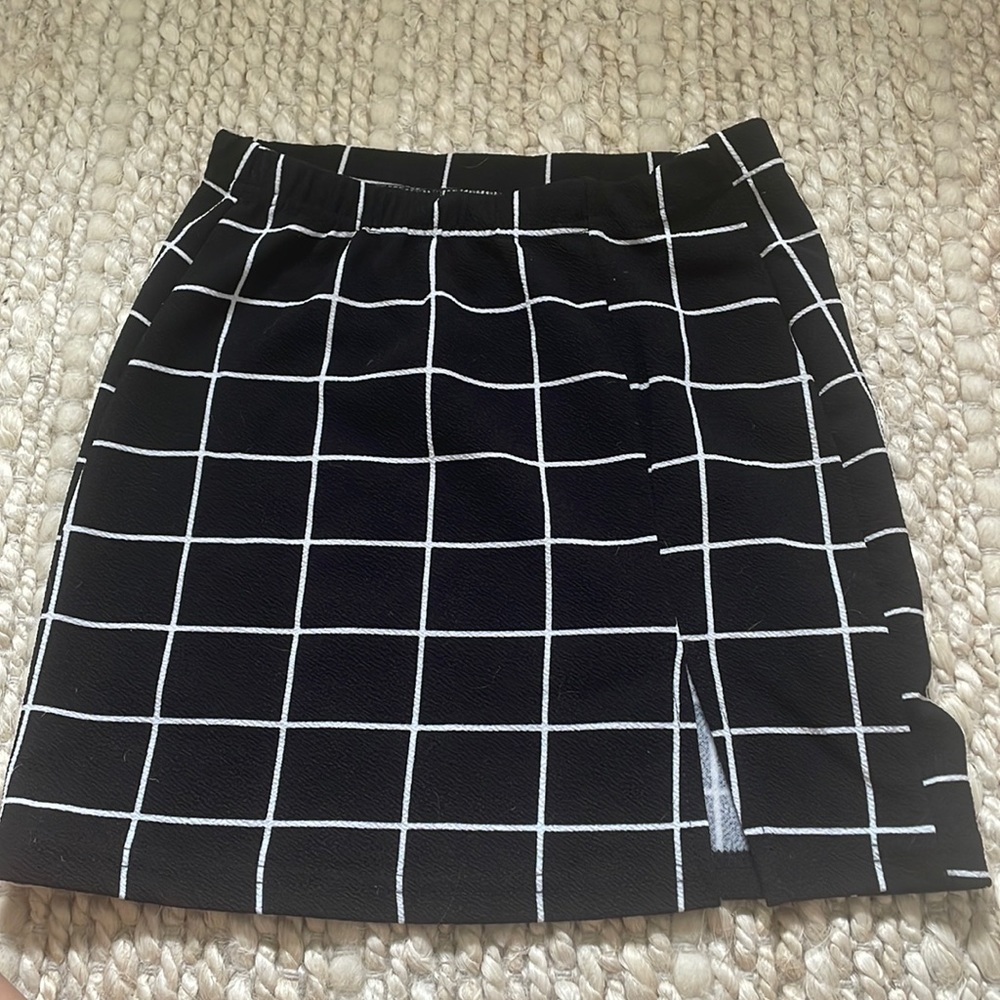 Shein black and white checkered mini skirt. Material is polyester. XS.